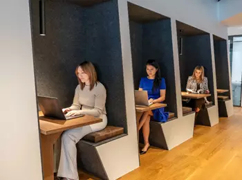 Clients working in a modern coworking shared space in booths in Servcorp 139 Quay Street, Auckland