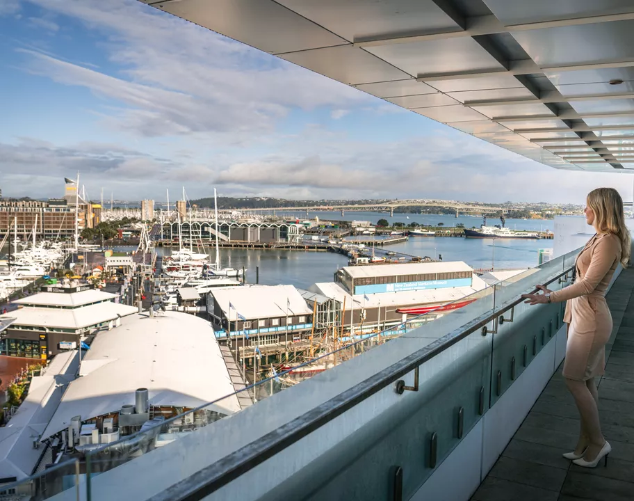 A client admiring the views from a balcony in Servcorp 139 Quay Street, Auckland